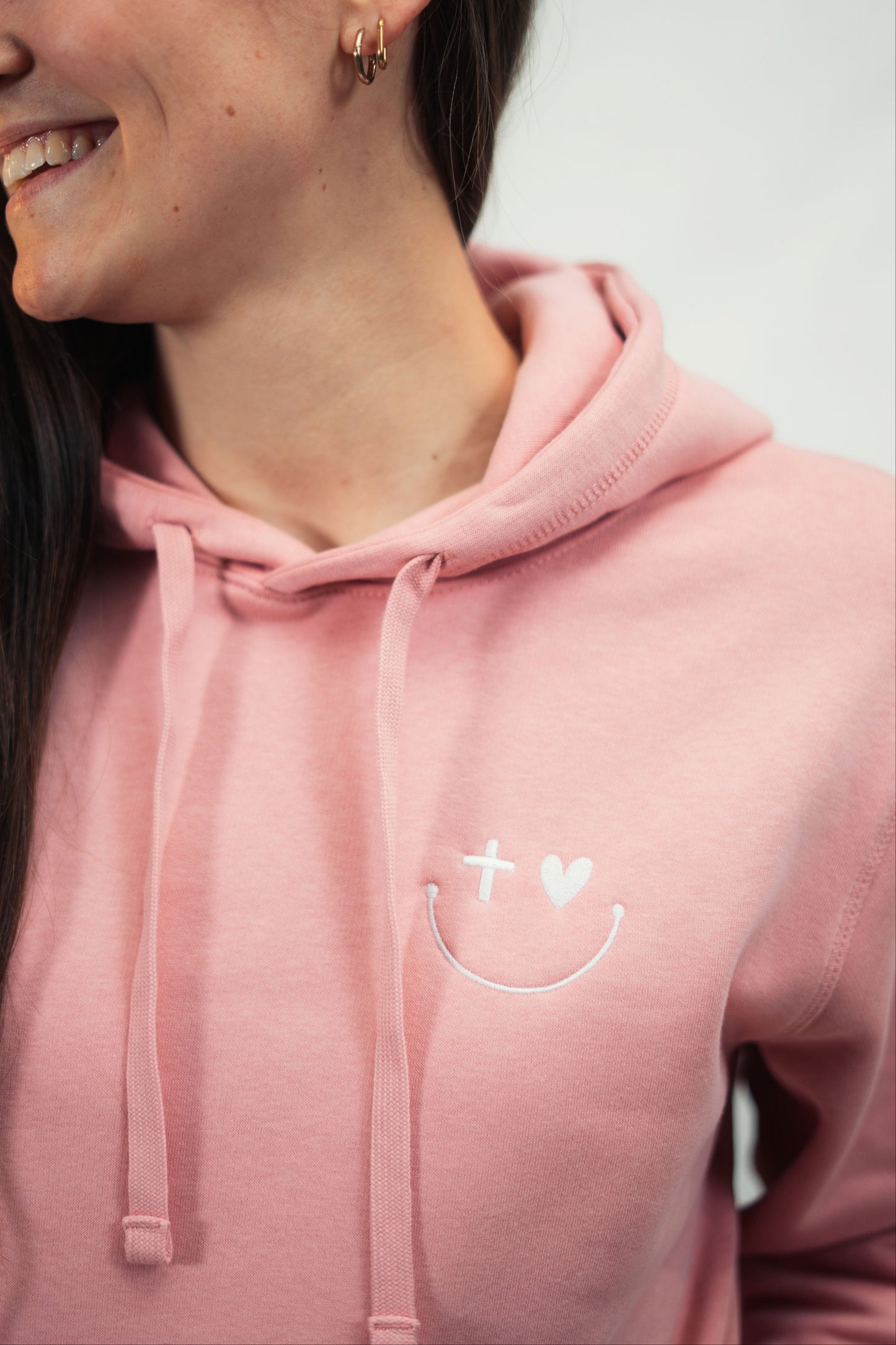 Model präsentiert in Nahaufnahme Mission One More ‚Smile‘ Hoodie aus hochwertiger Bio Baumwolle